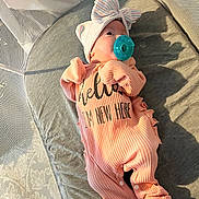 Elena joined the competition — help win amazing prizes! baby, infant, pacifier, pink_onesie, bow_hat, mesh_playpen, cushion, gray_cushion, baby_clothing, newborn, indoor, soft_light, shadow, sleepwear, child, cute, resting, portrait, baby_accessory, cozy