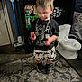 Michele joined the competition — help win amazing prizes! toddler, child, indoor, carpet, toy, clothing, dinosaur, shorts, shoes, chain, cabinet, cleaning_supplies, bottle, toy_toilet, floor, person, blur, home, play, furniture