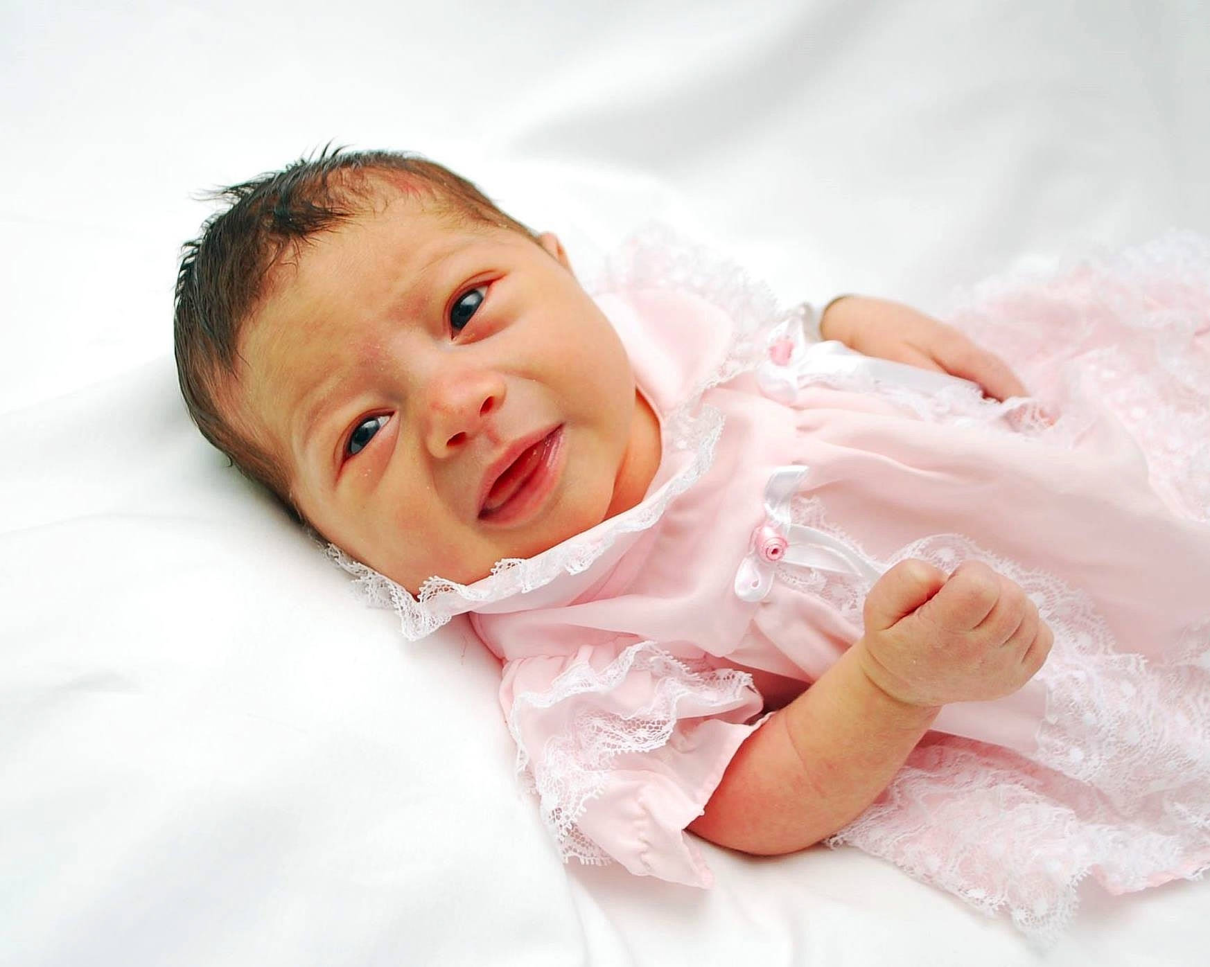 Isabell is registered to the contest to win money with this photo: baby, baby_toddler_clothing, cheek, child, collar, comfort, event, eye, eyebrow, face, flash_photography, gesture, happy, linens, lip, person, skin, sleeve, smile, textile