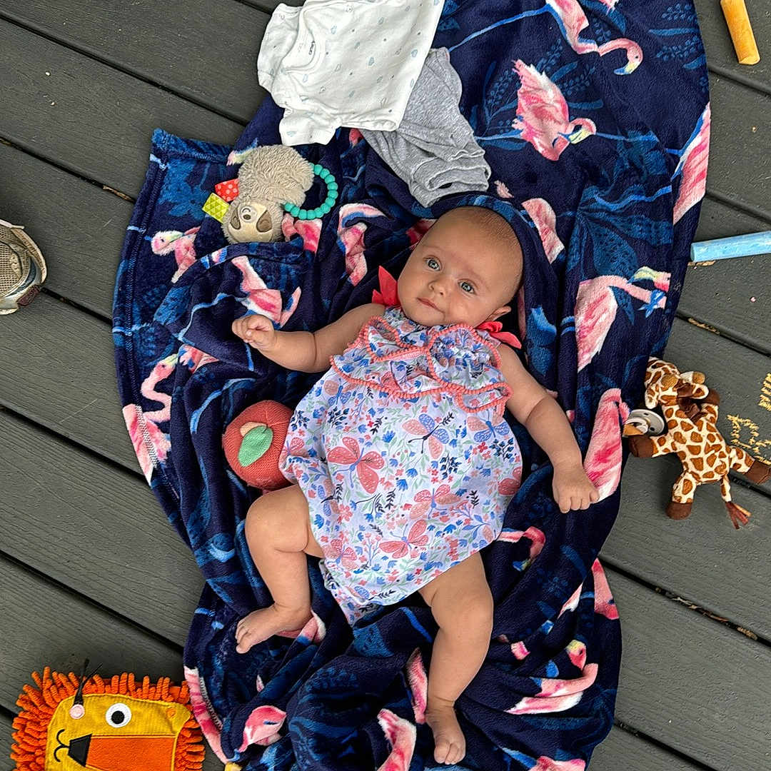 Izzabella is registered to the contest to win money with this photo: baby, blanket, clothing, dress, face, footwear, hat, head, jeans, pants, people, person, photography, portrait, quilt, sandal, shoe, shorts, sitting, sneaker