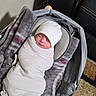 baby, baby_carrier, blanket, carpet, child, comfortable, cozy, floor, gray_blanket, hat, indoor, infant, leather_couch, newborn, peaceful, portrait, resting, sleeping, soft, swaddled