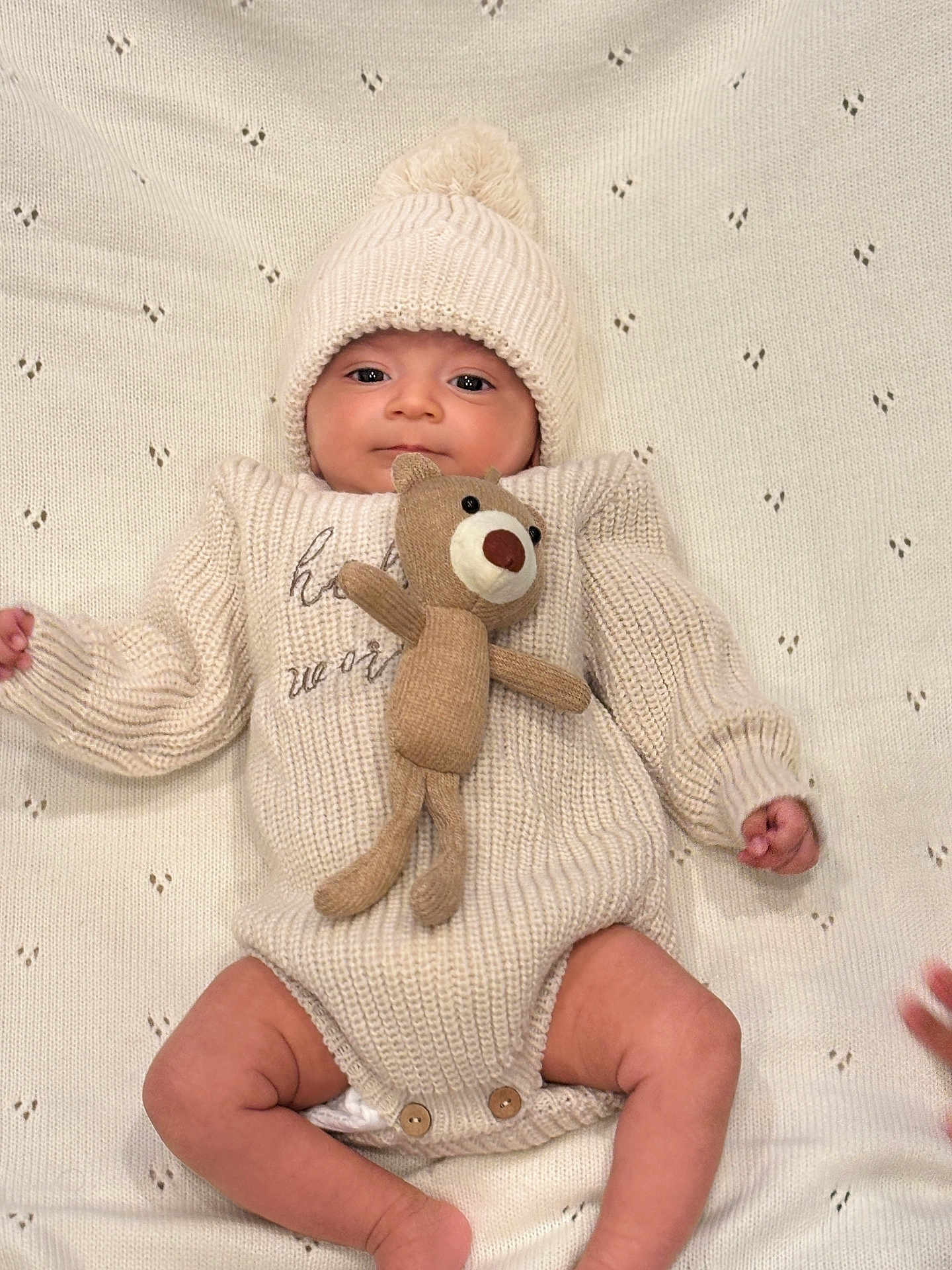 Aryansh joined the competition — help win amazing prizes! baby, infant, knitted_hat, knitted_outfit, plush_toy, teddy_bear, blanket, cute, soft_texture, indoors, portrait, child, smiling, lying_down, warm_clothing, newborn, comfortable, small_hands, small_feet, cozy