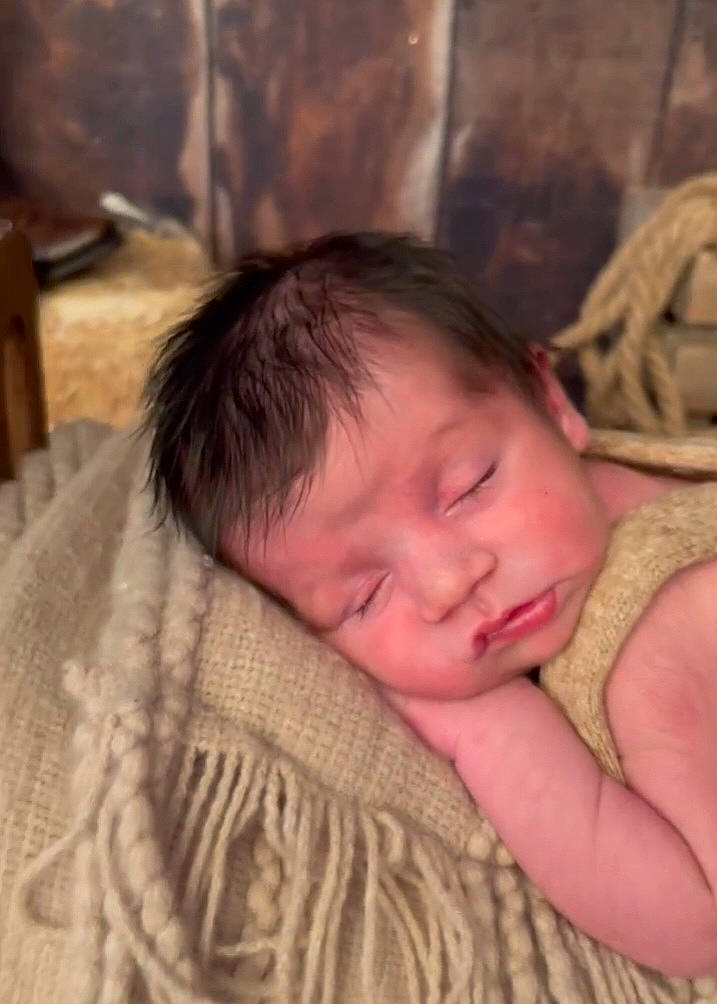 Bryson is registered to the contest to win money with this photo: baby, bedtime, cheek, child, comfort, eye, eyebrow, face, finger, fur, happy, head, iris, linens, nap, nose, person, skin, toddler, wood