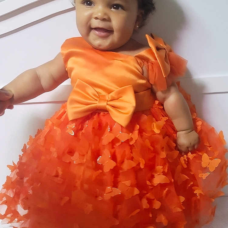 Ariana is registered to the contest to win money with this photo: accessories, baby, bodypart, clothing, costume, dress, eveningdress, face, fashion, finger, flower, formalwear, hand, happy, head, person, photography, plant, portrait, toy