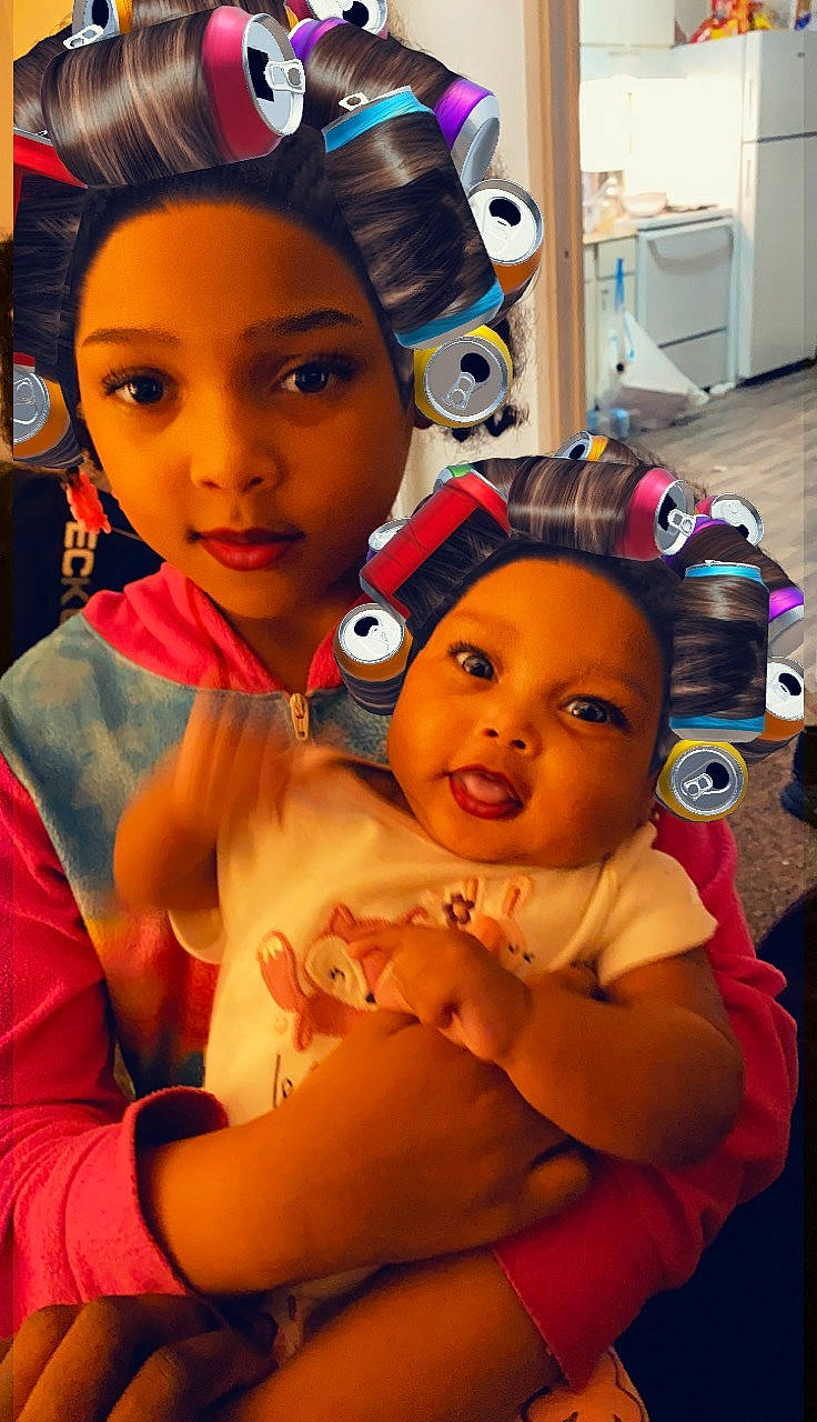 Destany is registered to the contest to win money with this photo: baby, cap, child, ear, event, eye, eyelash, eyewear, facial_expression, fashion_accessory, fun, gesture, happy, head, headwear, jewellery, necklace, person, pink, room