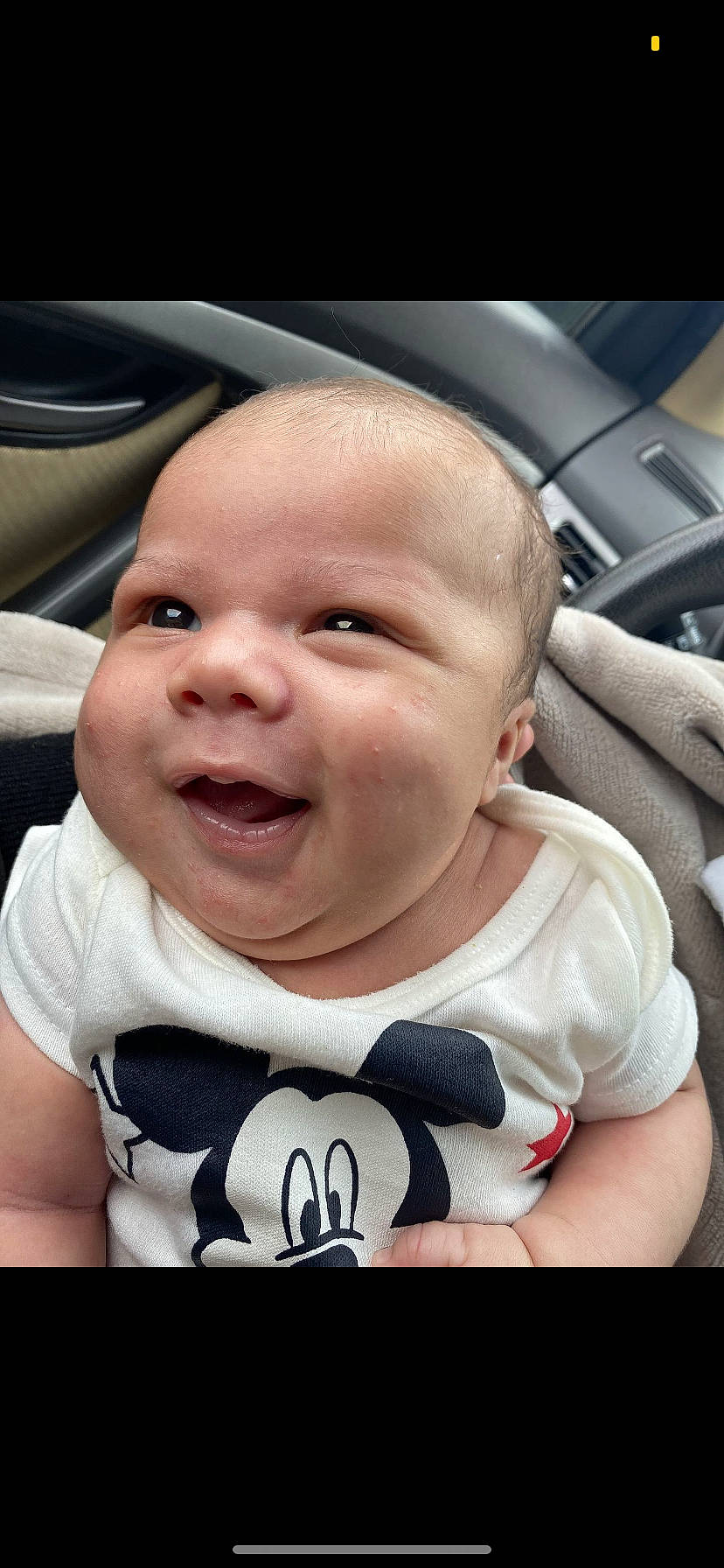 Jakobe is registered to the contest to win money with this photo: auto_part, baby, baby_toddler_clothing, black, cheek, child, comfort, cool, facial_expression, finger, flash_photography, grass, happy, human, person, product, skin, smile, t_shirt, toddler