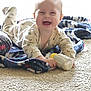 baby, blanket, bottle, carpet, child, clothing, cozy, crawling, cute, face, floor, happy, indoor, infant, milk, person, playtime, smiling, toy, young