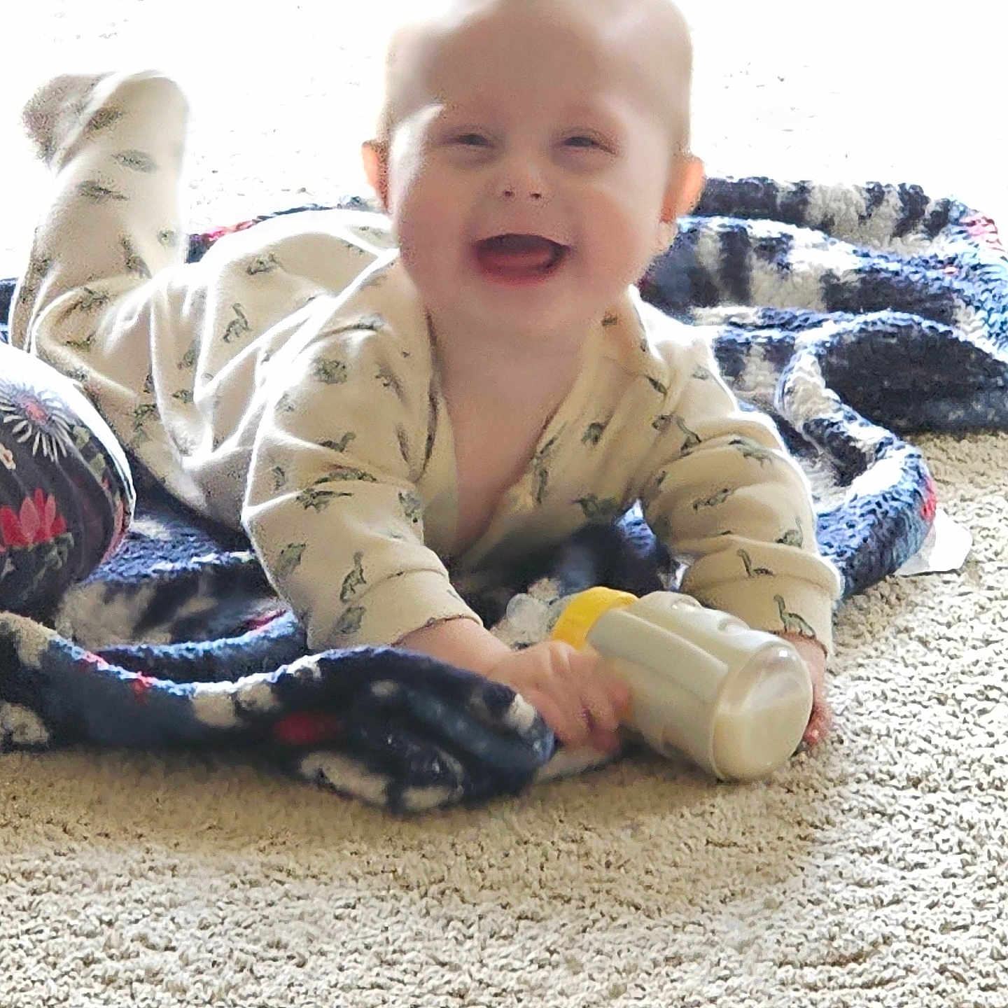Robert is registered to the contest to win money with this photo: baby, blanket, bottle, carpet, child, clothing, cozy, crawling, cute, face, floor, happy, indoor, infant, milk, person, playtime, smiling, toy, young