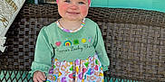 Claire joined the competition — help win amazing prizes! child, colorful_clothing, cushion, cute, dress, green_wall, happy, headband, knee_socks, outdoor, patterned_fabric, person, pink_bow, portrait, smile, standing, toddler, white_shoes, wicker_bench, window