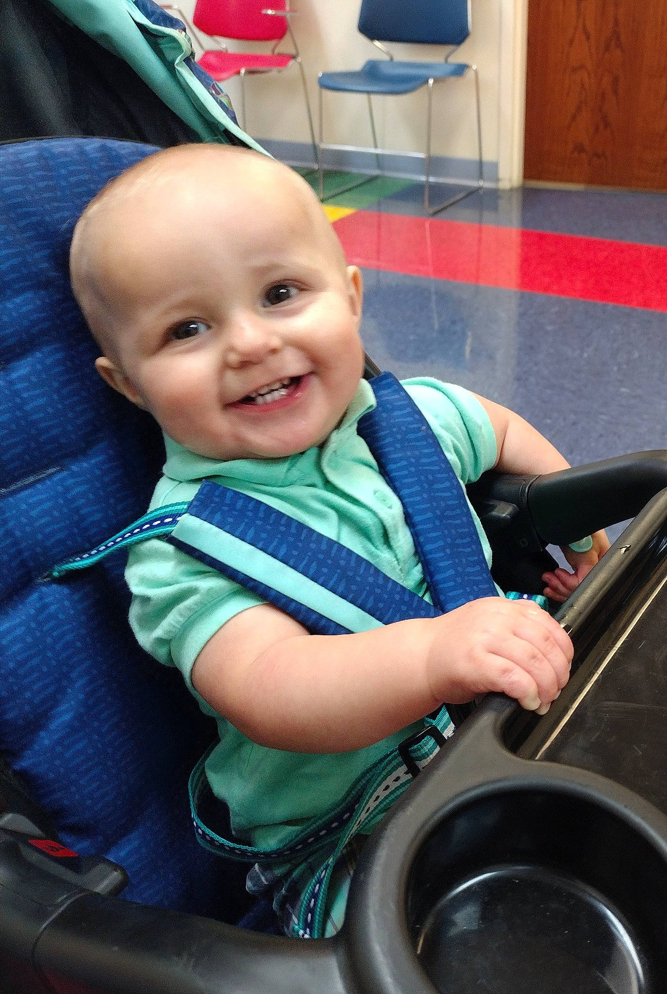 Karter is registered to the contest to win money with this photo: auto_part, automotive_tire, automotive_wheel_system, baby, baby_toddler_clothing, blue, chair, child, drum, electric_blue, fun, happy, joy, leisure, motor_vehicle, person, sitting, smile, steering_wheel, t_shirt