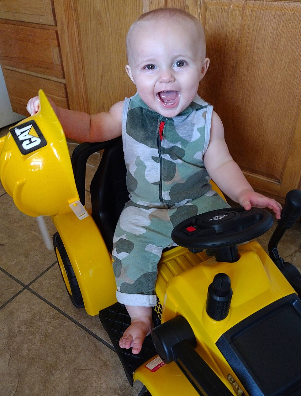 Karter is registered to the contest to win money with this photo: baby, baby_playing_with_toys, baby_products, baby_toddler_clothing, child, cleanliness, fun, happy, lap, person, plastic, play, recreation, riding_toy, sitting, smile, tire, toddler, toy_vehicle, vehicle