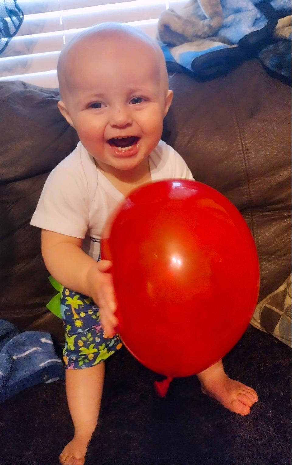 Karter is registered to the contest to win money with this photo: baby, baby_playing_with_toys, baby_toddler_clothing, ball, balloon, chest, child, finger, fun, happy, head, human_body, joy, leg, nose, party_supply, person, shorts, smile, t_shirt