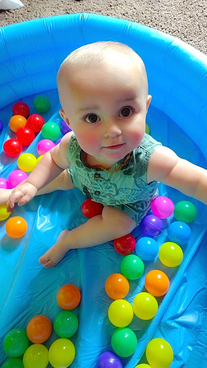 Karter is registered to the contest to win money with this photo: baby_playing_with_toys, baby_toddler_clothing, ball_pit, balloon, beauty, blue, child, event, fun, leisure, party_supply, person, photograph, plastic, play, product, snapshot, summer, toddler, toy
