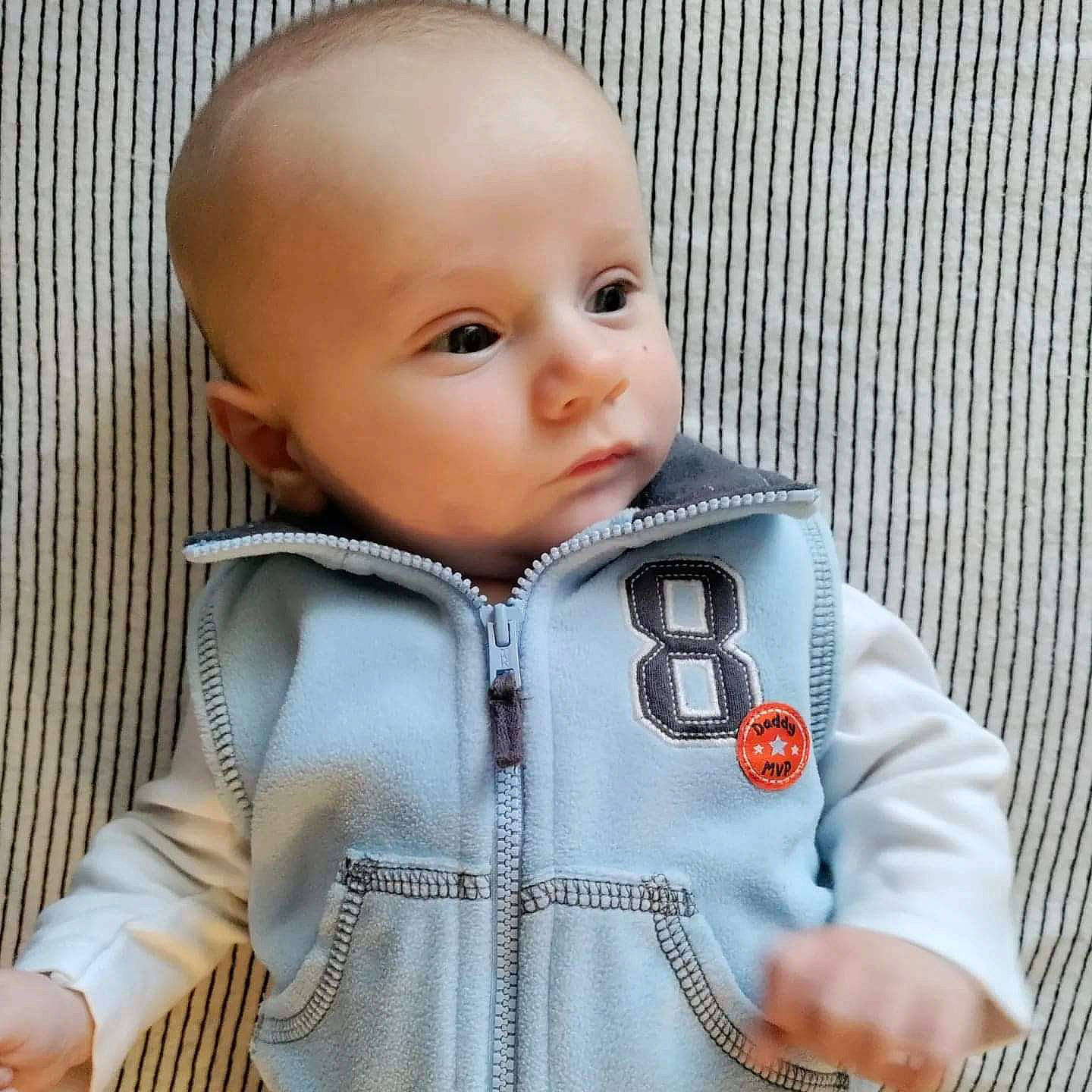Joe is registered to the contest to win money with this photo: baby, baby_toddler_clothing, cheek, child, collar, comfort, eyelash, fashion_accessory, hood, jacket, lip, neck, nose, outerwear, pattern, person, skin, sleeve, textile, toddler