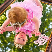 Alexis is registered to the contest to win money with this photo: baby, child, infant, pink_dress, dress, headpiece, tiara, jewelry, mirror, reflection, upside_down, outdoor, grass, trees, bokeh, portrait, fashion, frills, ornate_frame, photography