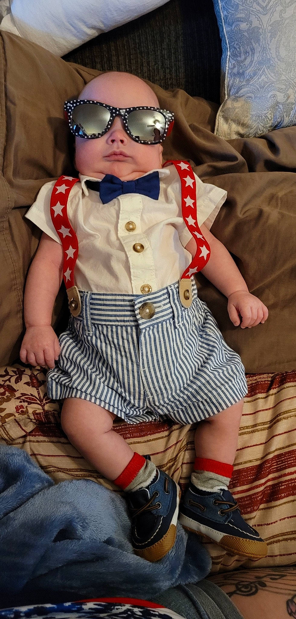 Jakobi is registered to the contest to win money with this photo: baby_toddler_clothing, clothing, cool, eyewear, fashion_design, glasses, goggles, hat, headwear, lip, pattern, person, skin, sleeve, sun_hat, sunglasses, tartan, thigh, tie, toddler