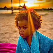 Kecy joined the competition — help win amazing prizes! child, towel, beach, sunset, sand, curly_hair, tear, blue_towel, golden_hour, sunbeam, outdoor, portrait, sad, young, person, nature, warm_light, reflection, emotion, serene