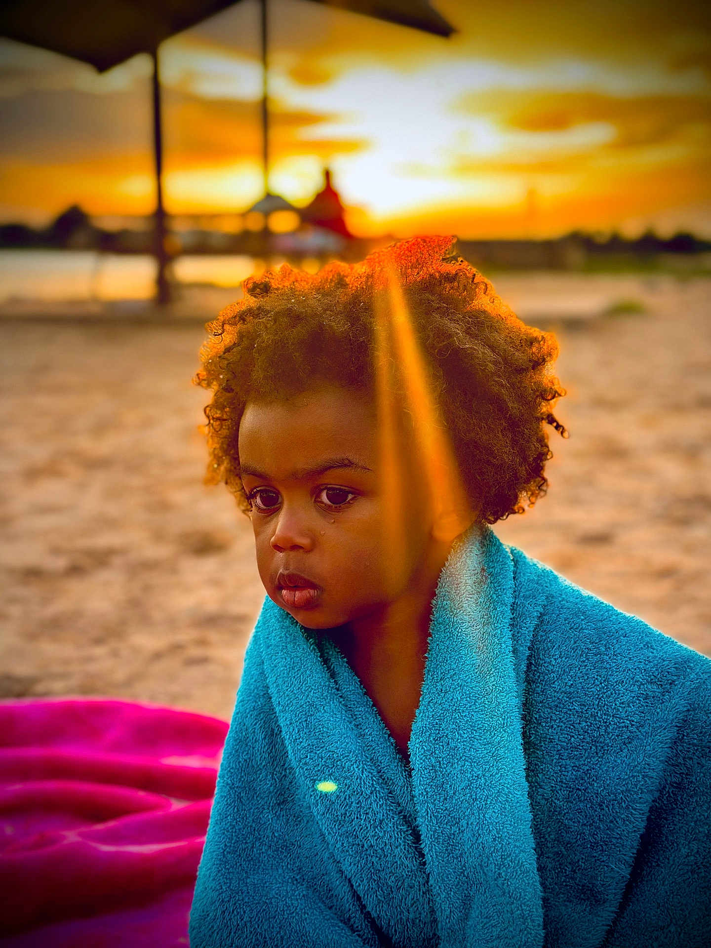 Kecy joined the competition — help win amazing prizes! child, towel, beach, sunset, sand, curly_hair, tear, blue_towel, golden_hour, sunbeam, outdoor, portrait, sad, young, person, nature, warm_light, reflection, emotion, serene