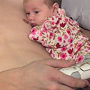 Willow joined the competition — help win amazing prizes! adult_torso, baby, bed, child, close_up, controller, cuddling, cute, floral_pattern, hand, indoor, infant, jeans, onesie, pillow, portrait, resting, skin, sleepy, video_game_controller