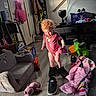 Amethyst is registered to the contest to win money with this photo: blanket, child, clothing, couch, curly_hair, door, floor, furniture, indoor, light, living_room, person, pink_jacket, play, shoes, stuffed_animal, television, toddler, toy, window