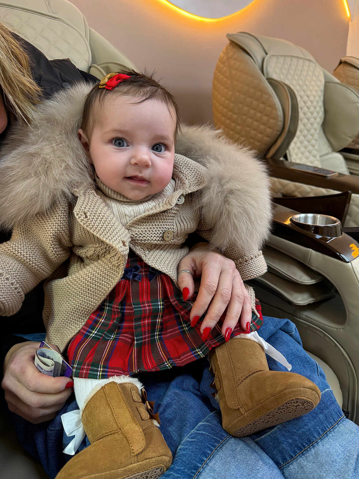 Vienna joined the competition — help win amazing prizes! baby, child, person, sitting, knit_sweater, fur_collar, plaid_skirt, boots, bow, hand, nail_polish, jeans, chair, quilted_chair, indoor, portrait, cute, cozy, warm_lighting, fashion