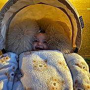 Vienna joined the competition — help win amazing prizes! baby, blanket, bear_pattern, fur_hood, stroller, child, cozy, cute, smiling, face, fur_trim, warm, outdoor, night, person, clothing, infant, wrapped, happy, cute_face