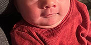 Teagan joined the competition — help win amazing prizes! baby, infant, face, red_sweater, clothing, skin, person, portrait, cute, eyes, newborn, cozy, soft, indoor, closeup, expression, child, head, sitting, young