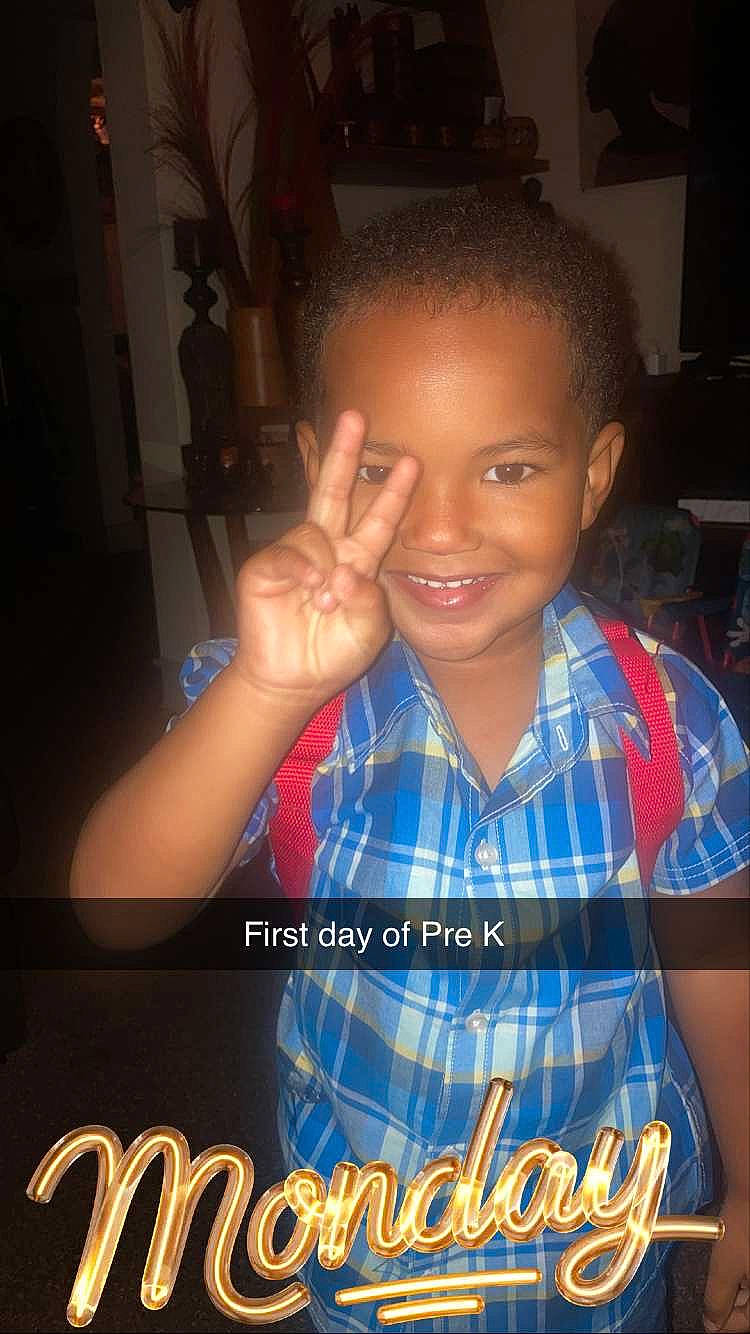 Eli is registered to the contest to win money with this photo: afro, child, chin, cool, electric_blue, flash_photography, font, forehead, fun, gesture, happy, jheri_curl, joy, logo, pattern, person, photo_caption, sleeve, smile, t_shirt