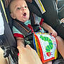 Brooks joined the competition — help win amazing prizes! baby, car_seat, child, infant, seatbelt, soft_book, hand, surprised_expression, colorful, caterpillar, toy, clothing, indoor, person, seat, safety, closeup, cute, young_child, transportation