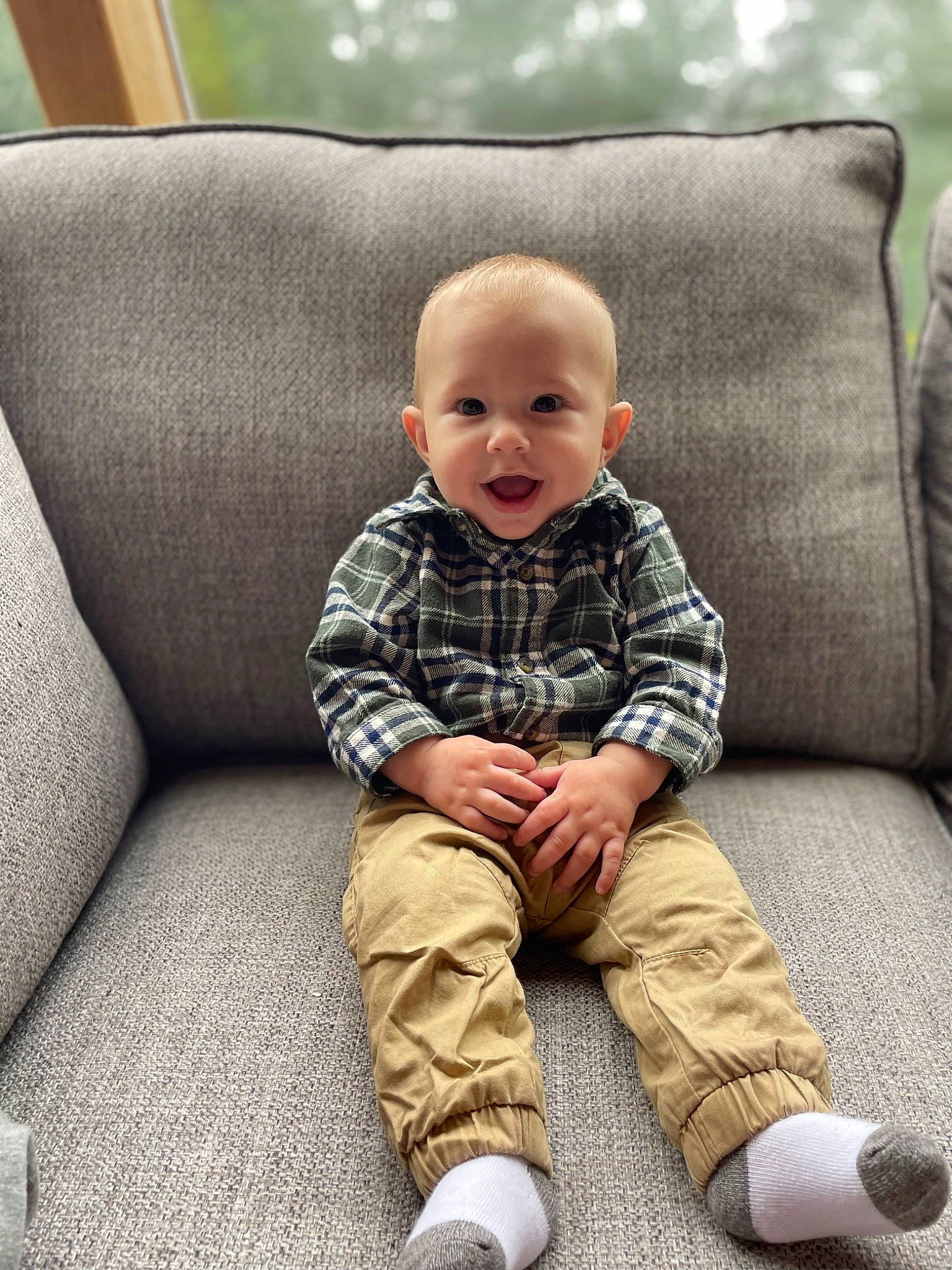 Holden is registered to the contest to win money with this photo: baby, baby_toddler_clothing, beauty, cheek, child, collar, comfort, couch, eye, facial_expression, hairstyle, happy, head, outerwear, person, skin, sleeve, smile, toddler, white