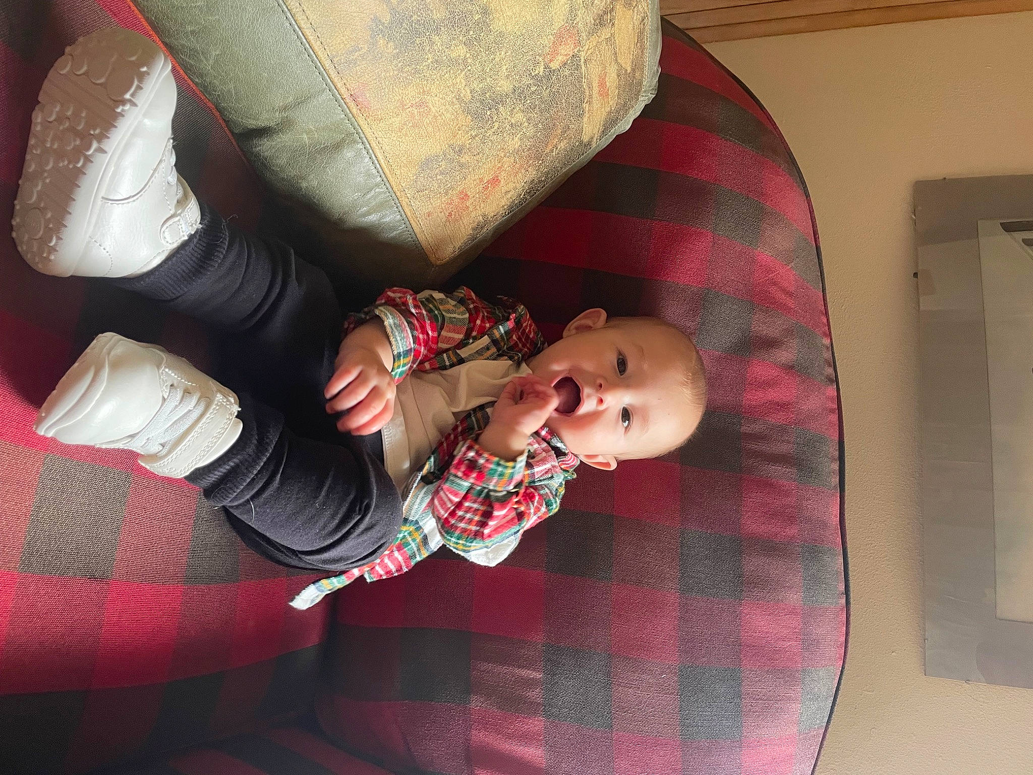 Holden is registered to the contest to win money with this photo: baby, baby_products, baby_toddler_clothing, carmine, child, comfort, flooring, gesture, human_leg, lap, linens, pattern, person, plaid, sitting, skin, sleeve, sock, tartan, toddler