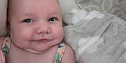 Adeline is registered to the contest to win money with this photo: baby, infant, smile, blanket, cushion, face, skin, cheeks, arm, clothing, indoors, portrait, cute, babywear, child, soft, resting, comfort, young, expression