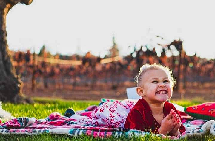 Helena is registered to the contest to win money with this photo: baby, fun, grass, grassland, green, happy, joy, lawn, leaf, leisure, meadow, morning, natural_landscape, people_in_nature, person, plant, recreation, sky, smile, sunlight