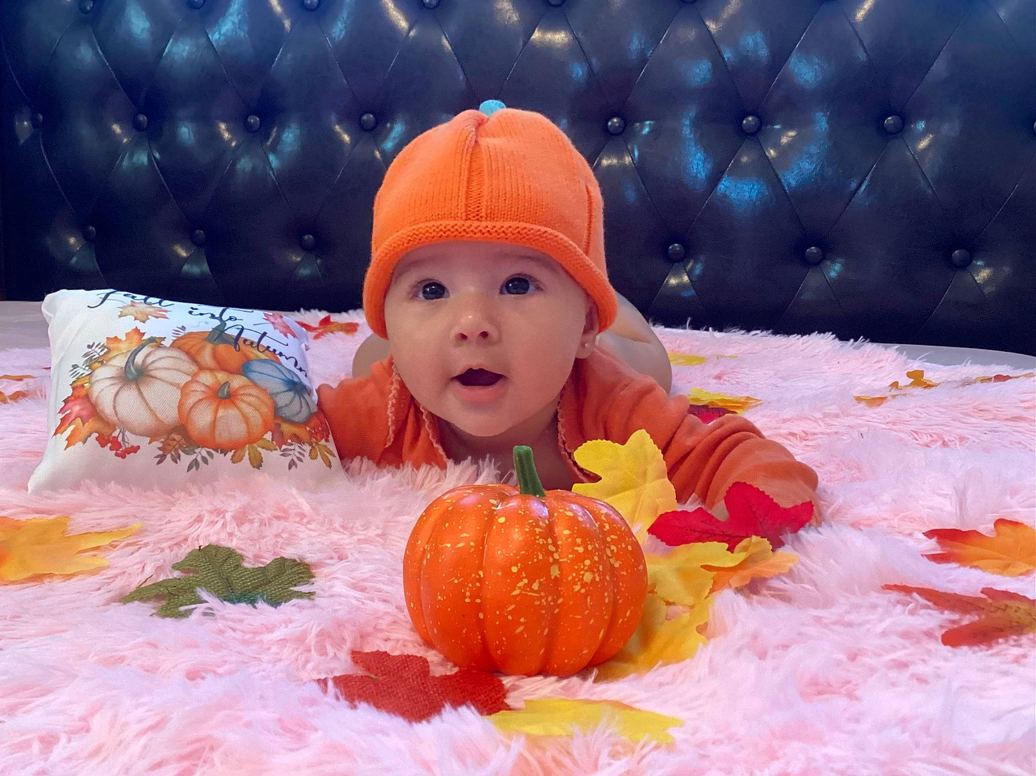 Allison is registered to the contest to win money with this photo: baby, baby_toddler_clothing, cap, child, freezing, fun, happy, headwear, knit_cap, leisure, natural_foods, orange, people_in_nature, person, play, playing_with_kids, pumpkin, recreation, smile, snow
