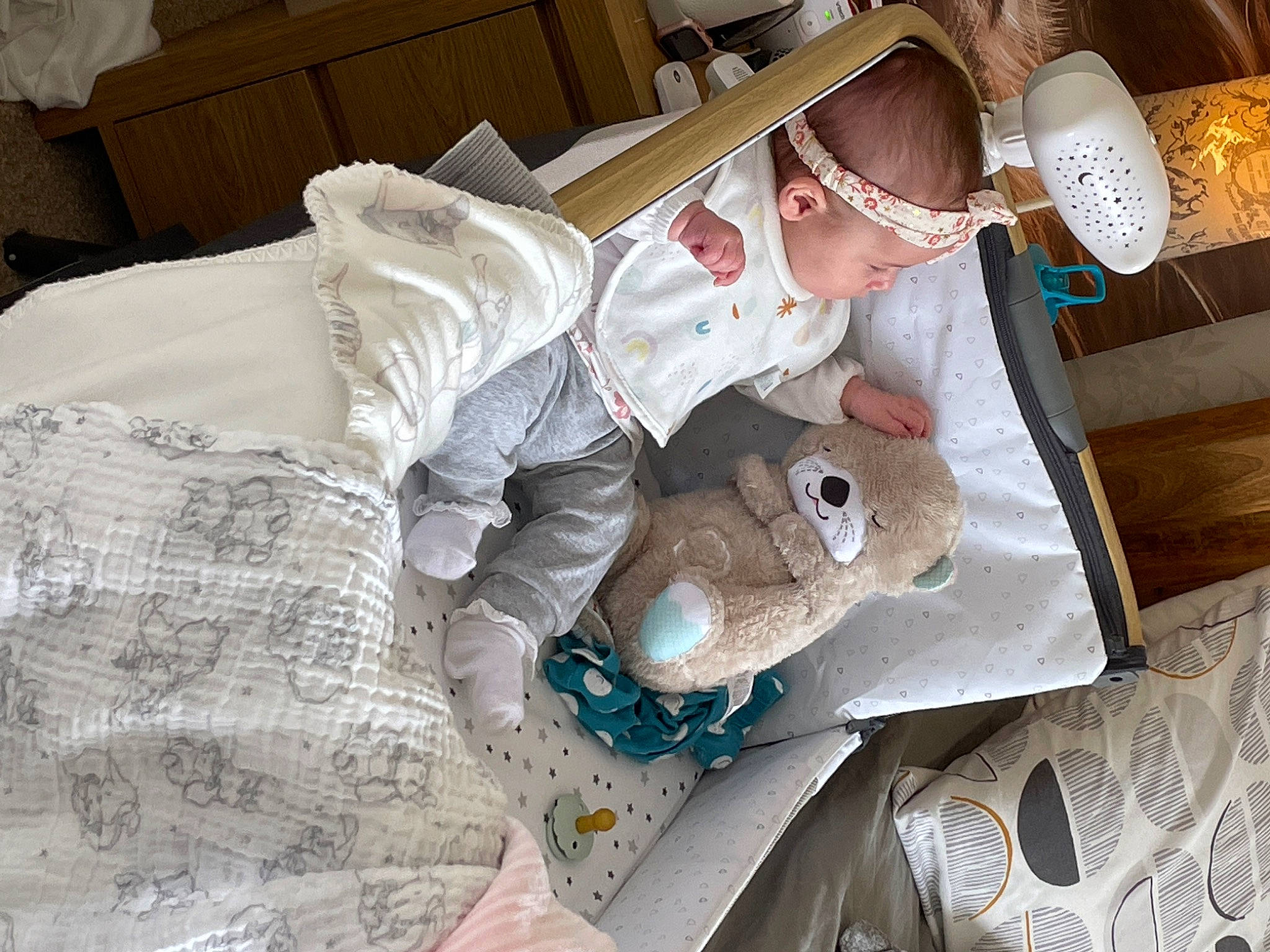 Maddison is registered to the contest to win money with this photo: baby, baby_toddler_clothing, bed_sheet, bedding, bedroom, blanket, child, comfort, hat, linens, paper, paper_product, pattern, person, plastic, plastic_bag, room, sleeve, t_shirt, textile