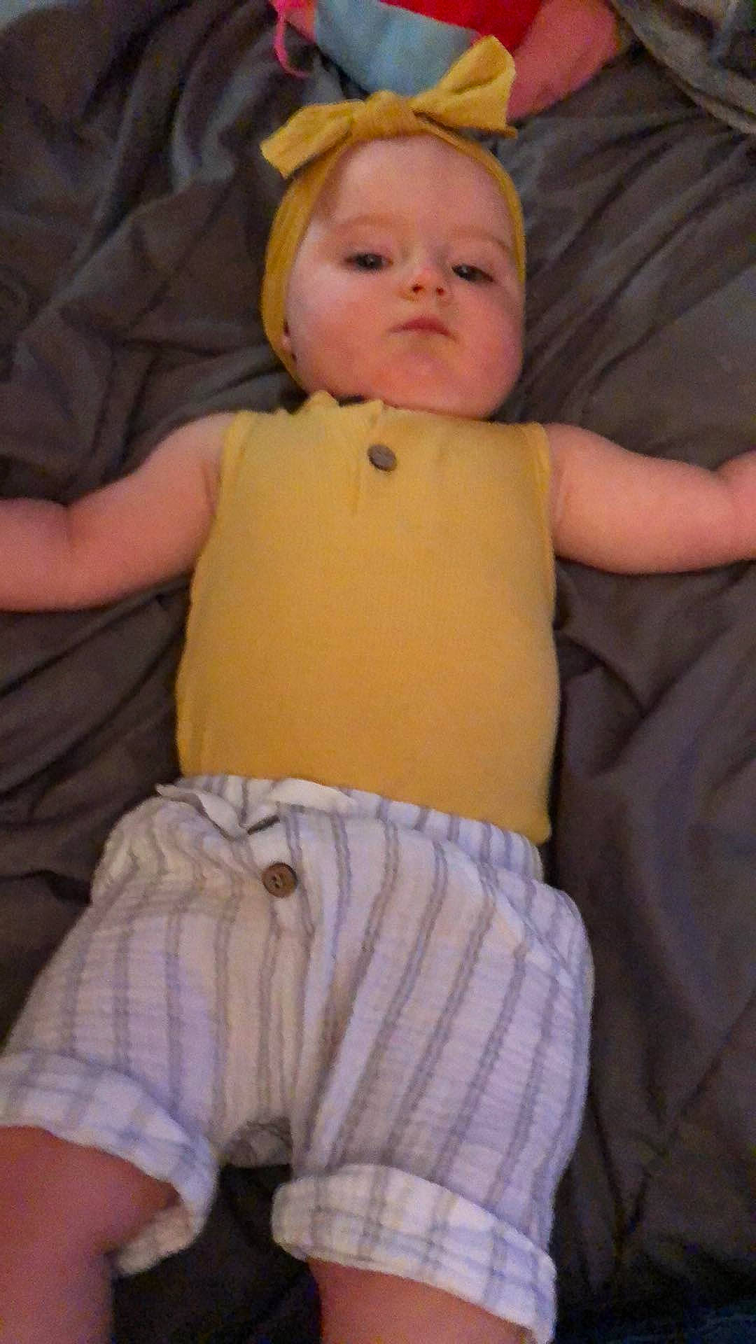 Scarlett is registered to the contest to win money with this photo: baby, baby_toddler_clothing, cheek, chest, child, chin, comfort, eye, finger, gesture, mouth, nose, organ, people, person, skin, sleeve, stomach, thumb, toddler