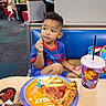 Elijah joined the competition — help win amazing prizes! child, boy, pizza, fries, drink, cup, table, restaurant, food, casual_clothing, blue_outfit, spiderman, sitting, curious, indoor, family, people, plate, fast_food, colorful