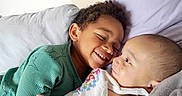 Elijah is registered to the contest to win money with this photo: child, baby, siblings, smiling, bed, pillow, happy, face, cuddling, indoor, cute, family, portrait, clothing, resting, toddler, infant, skin, head, love