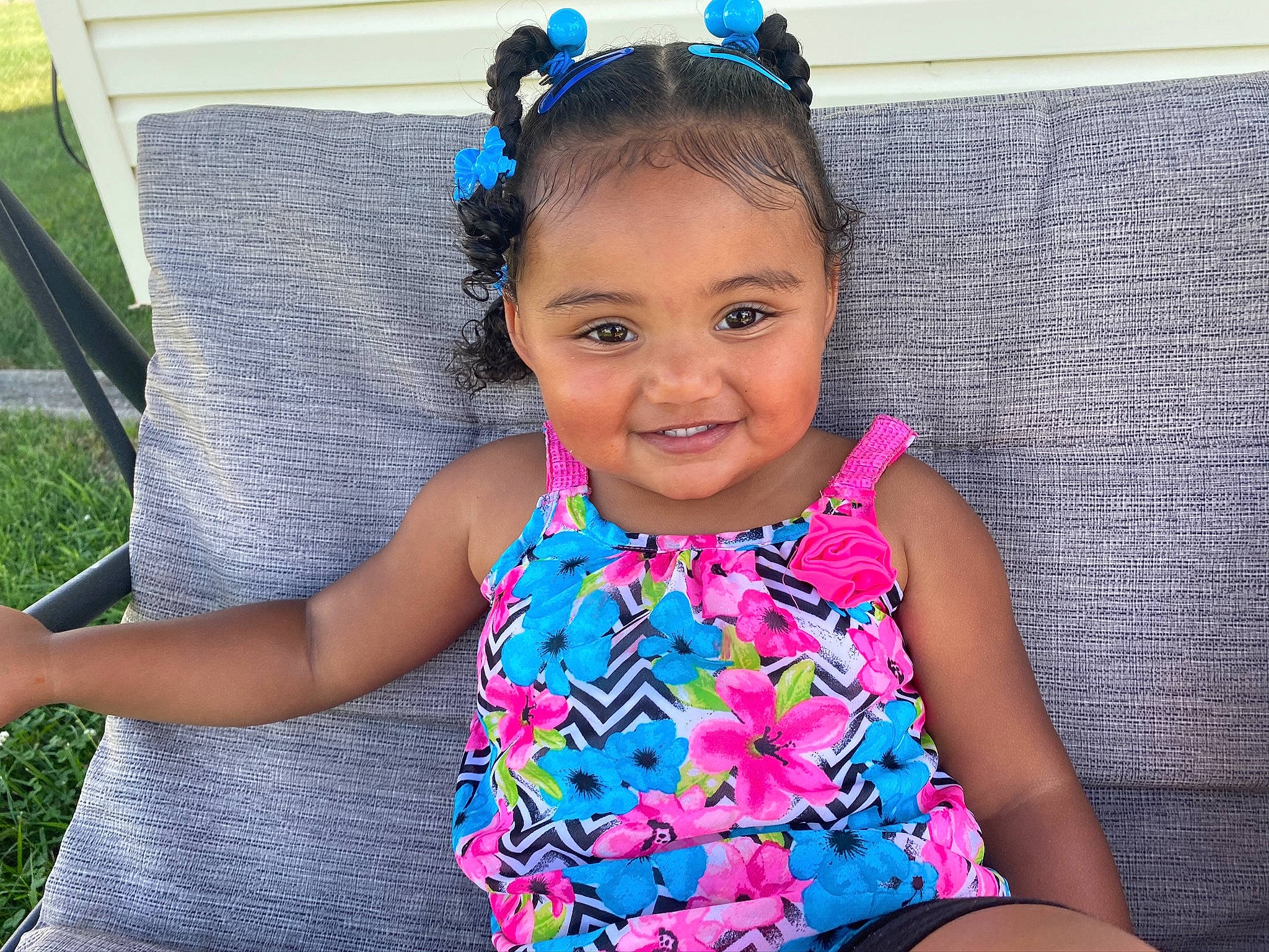 Nevaeh is registered to the contest to win money with this photo: baby_toddler_clothing, child, clothing, dress, ear, fashion_accessory, hair_accessory, happy, headband, headgear, joy, neck, pattern, person, pink, smile, sportswear, summer, swimwear, textile