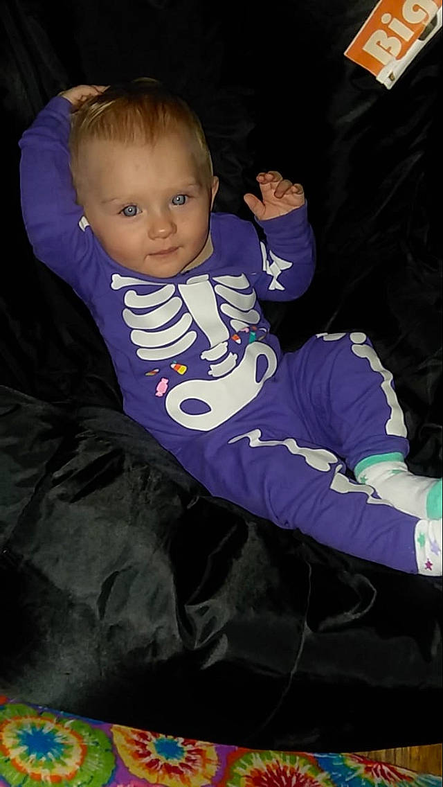 Ashlynn is registered to the contest to win money with this photo: baby, cheek, child, person, purple, sitting, skin, smile, toddler, violet