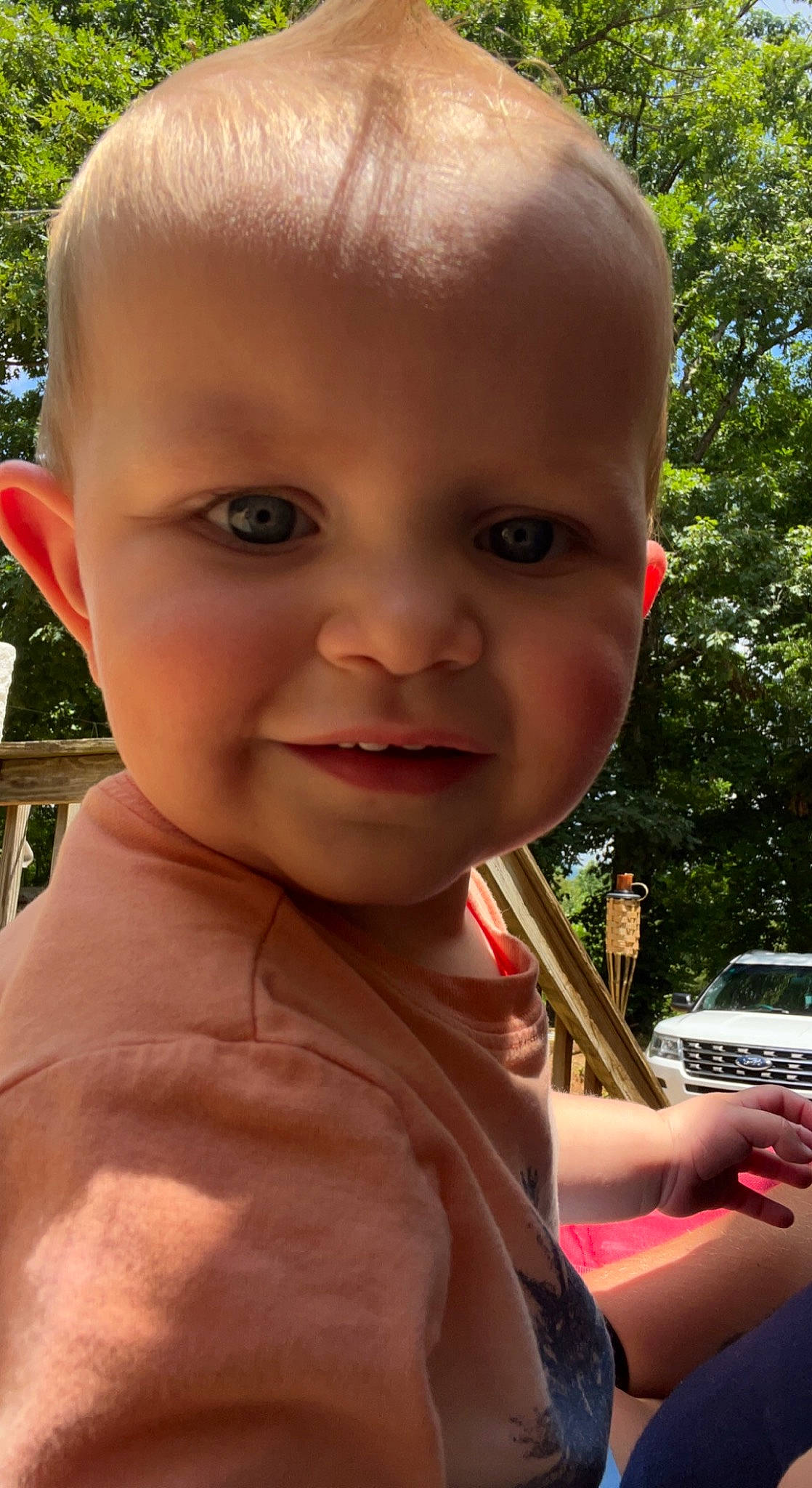 Gunnar joined the competition — help win amazing prizes! baby, cheek, chin, dress, eyebrow, eyelash, facial_expression, grass, hand, human, iris, lip, mouth, nose, person, plant, skin, sunlight, tire, tree