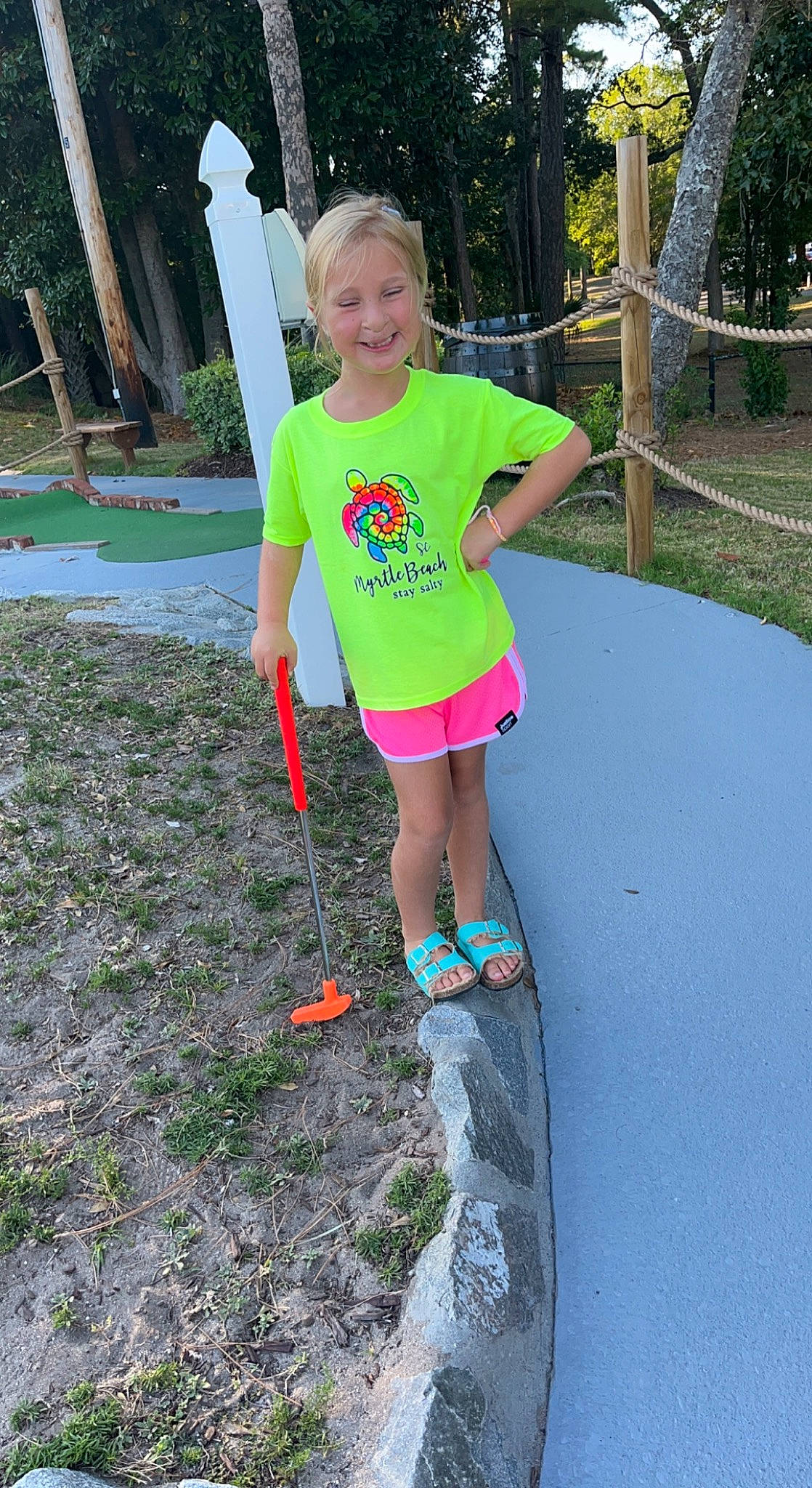 Olivia joined the competition — help win amazing prizes! asphalt, fun, grass, head, human_leg, joy, knee, leg, leisure, people_in_nature, person, pink, plant, recreation, shorts, sidewalk, smile, t_shirt, thigh, toddler