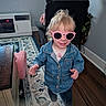 carpet, casual, chair, child, clothing, denim_jacket, face, hair, happy, home, indoor, person, pink, playful, rug, smile, sunglasses, table, toddler, wooden_floor