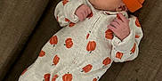 Layla is registered to the contest to win money with this photo: autumn_theme, baby, blanket, child, couch, cozy, cute, footed_pajamas, indoors, infant, newborn, onesie, orange_hat, peaceful, person, pumpkin_pattern, resting, sleeping, small_hands, soft_fabric