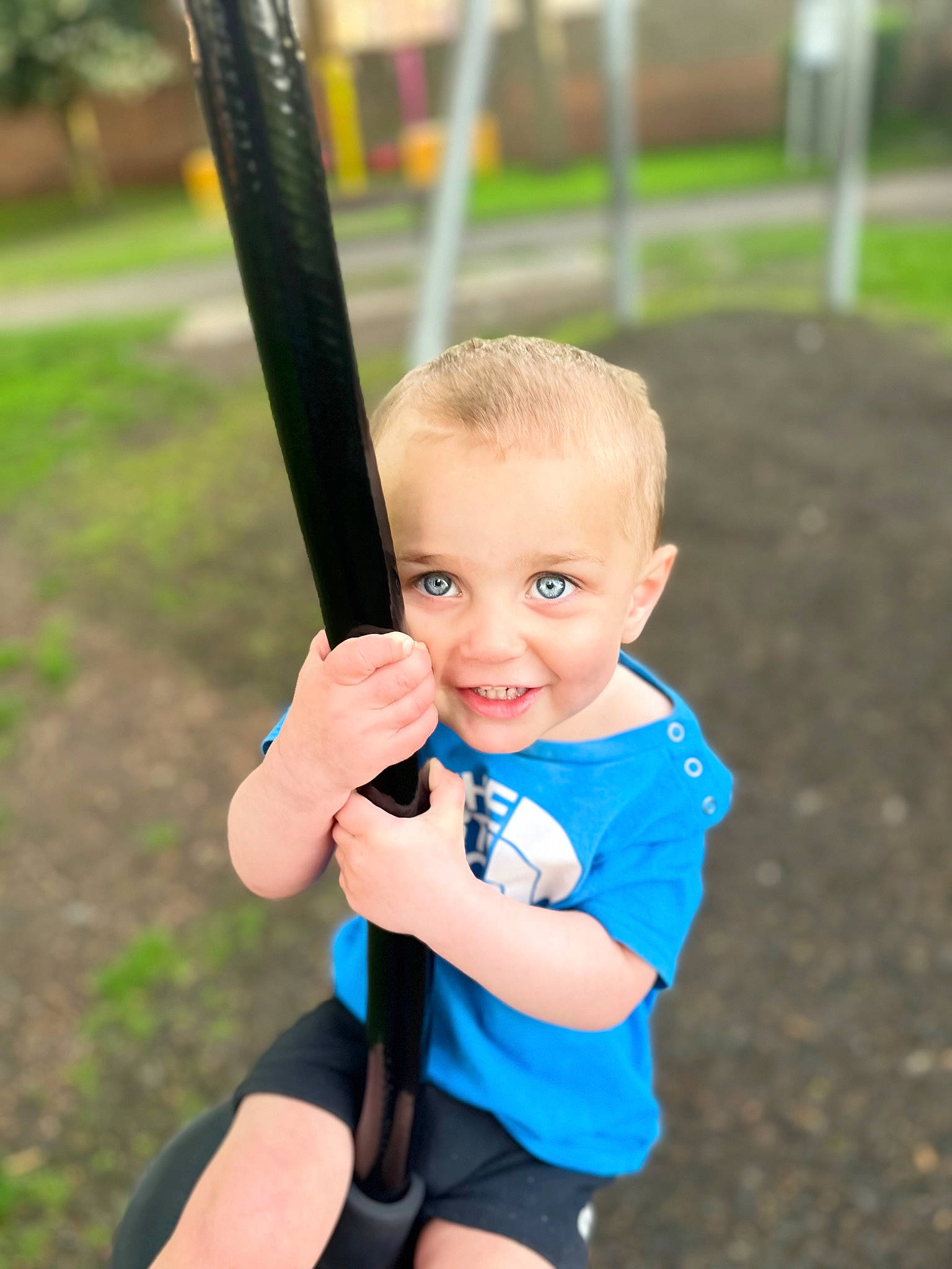 Kenston is registered to the contest to win money with this photo: child, city, electric_blue, fun, gesture, grass, happy, joy, leisure, outdoor_play_equipment, person, play, recreation, shorts, smile, soil, swing, t_shirt, thumb, toddler