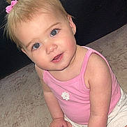 Ariella joined the competition — help win amazing prizes! toddler, child, blonde_hair, pink_bows, pink_tank_top, white_shorts, carpet, leather_couch, indoor, cute, sitting, holding_object, curious_expression, blue_eyes, baby, small_hands, floor, package, portrait, young_child