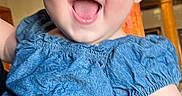 Ariella joined the competition — help win amazing prizes! baby, child, smiling, blue_clothing, headband, indoor, person, holding, happy, face, human_hand, pillar, lighting, portrait, cute, toddler, apparel, accessory, infant, cheerful