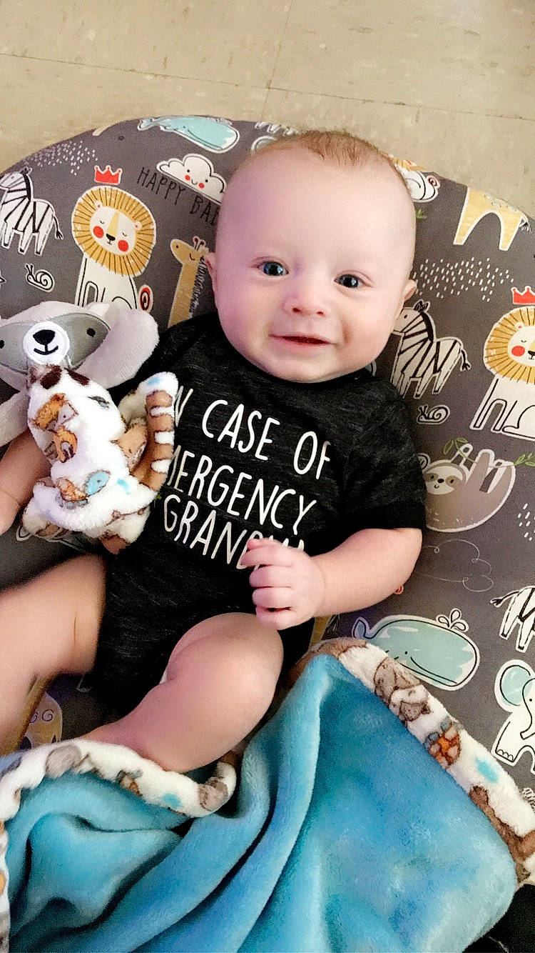 Elijah is registered to the contest to win money with this photo: baby, baby_toddler_clothing, cheek, child, finger, font, happy, headgear, joy, pattern, person, pink, product, skin, sleeve, smile, sock, stuffed_toy, t_shirt, textile