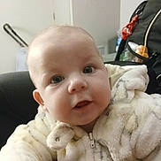 Judy Heavenly-Grace is registered to the contest to win money with this photo: baby, child, face, eyes, jacket, fur_clothing, indoor, curious, soft_texture, closeup, person, infant, cute, warm_clothing, expression, head, portrait, young, furniture, home