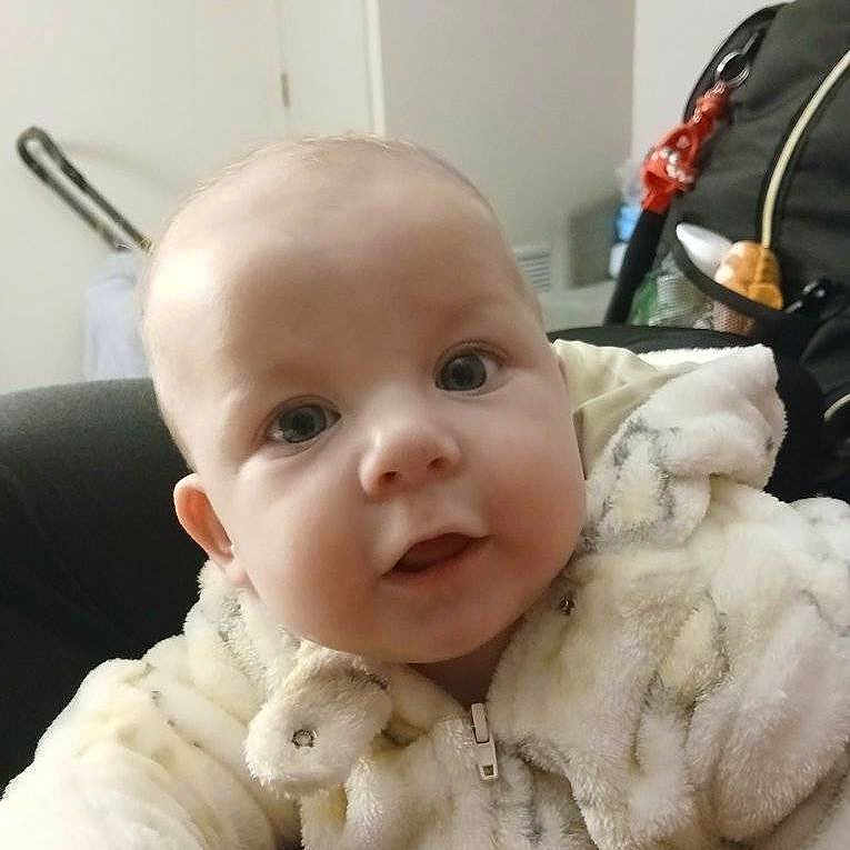 Judy Heavenly-Grace is registered to the contest to win money with this photo: baby, child, closeup, curious, cute, expression, eyes, face, fur_clothing, furniture, head, home, indoor, infant, jacket, person, portrait, soft_texture, warm_clothing, young